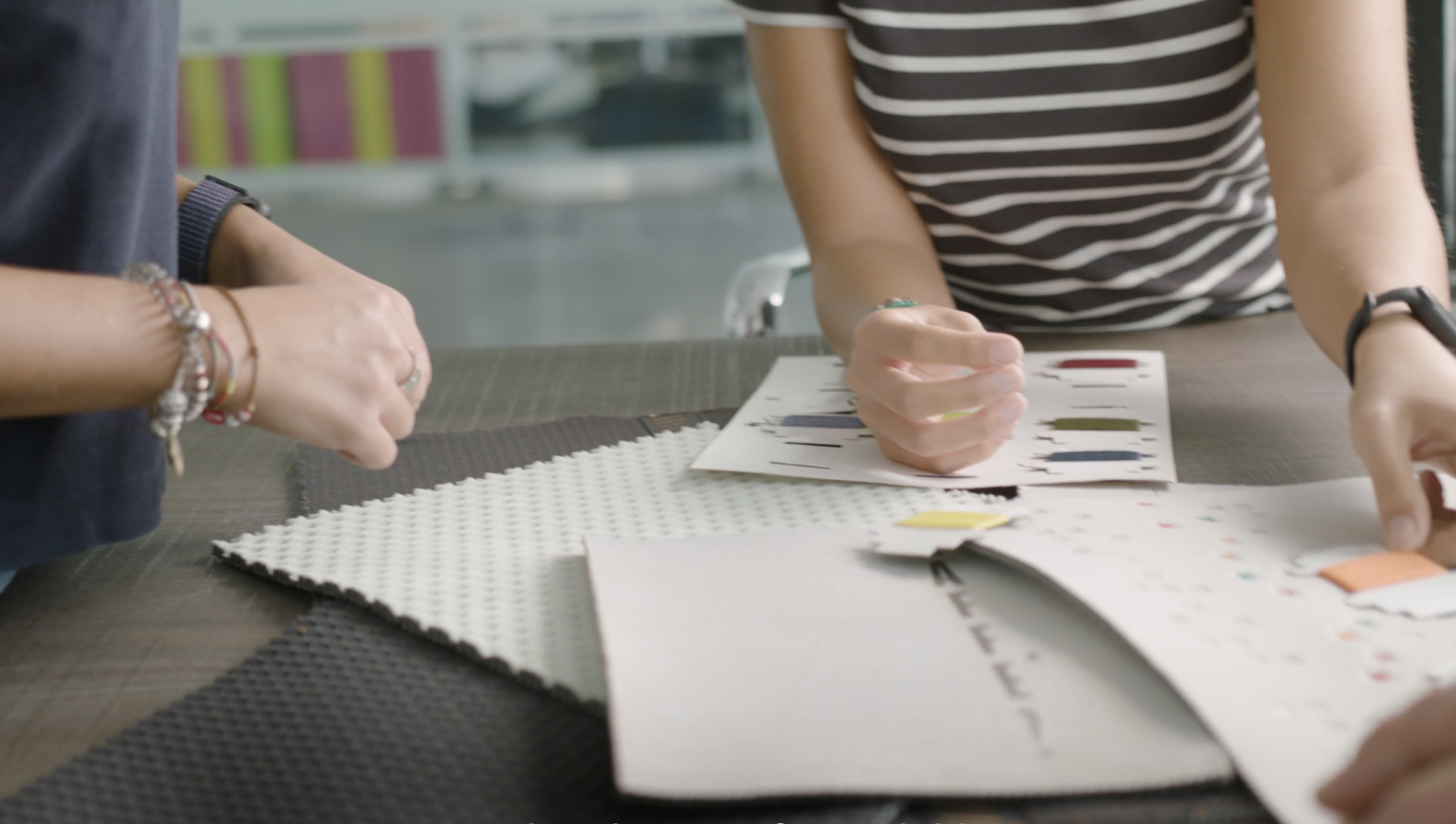 Designers looking over concepts of products and swatches